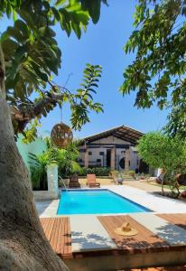 a swimming pool in front of a house at Pousada Maktub in Carolina