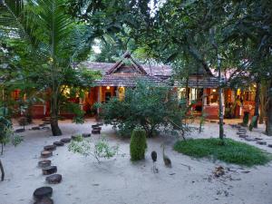 a courtyard with birds in front of a building at AbbA Marari Beach Villas & Homestay Mararikulam in Alleppey