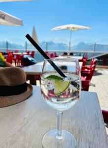 a glass of water with a lime on a table at Walliser Stadel in Fieschertal