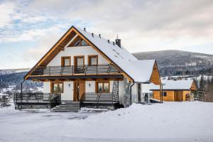 a house in the snow in the mountains at Domek Kordoń SPA Jacuzzi & Sauna in Zubrzyca Górna