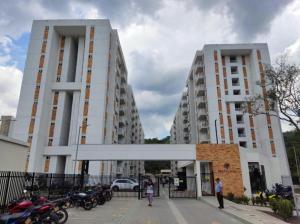 two tall buildings with motorcycles parked in front of them at Moderno apartamento cerca a la naturaleza in Villeta
