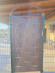 a garage door with a sign on top of it at Casa Rural La Veguilla in Argés