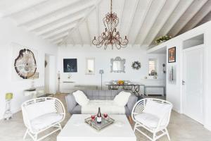 a living room with white furniture and a chandelier at Luxury Villa in Kechria 2 in Kechria