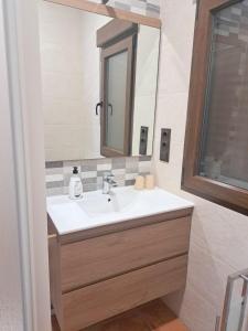 a bathroom with a sink and a mirror at Casa Rural La Veguilla in Argés