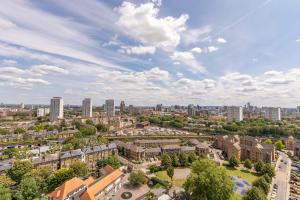 an aerial view of a city with buildings and trees at City View Apartments - Bow in London