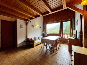 a living room with a table and a large window at Appartement Lanslevillard, 3 pièces, 4 personnes - FR-1-508-296 in Lanslebourg-Mont-Cenis