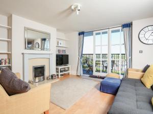 a living room with a couch and a fireplace at 15 Combehaven in Salcombe