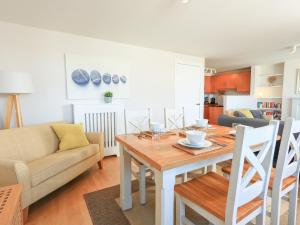 a kitchen and living room with a table and a couch at 15 Combehaven in Salcombe