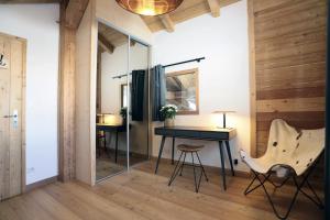 a room with a desk and a chair and a table at Chalet Ar Menez in Les Deux Alpes