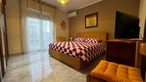a bedroom with a bed with a red and white blanket at Casa Vacanze La Melagrana in Modica