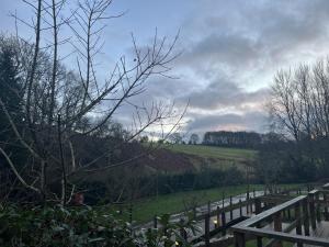 a wooden fence with a field in the background at Mountain Edge Resort Mega pod 2 with Hot Tub in Church Stretton