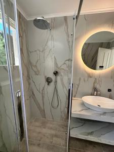 a bathroom with a shower and a sink at Christina's panoramic view appartment in Polychrono +34 photos