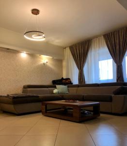 a living room with a couch and a coffee table at Federal Luxury in Drobeta-Turnu Severin