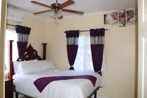 a bedroom with a bed and a ceiling fan at The Royal View (Fully AC) in Banbury