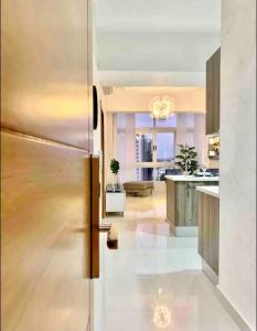 a kitchen and living room with a stainless steel refrigerator at 1BR Luxury apartment Pool, gym, rooftop Santo Domingo in Santo Domingo
