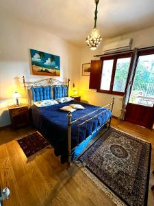 モンデッロにあるCasa Perciata - Locazione Turisticaのベッドルーム1室(青いシーツとラグ付)