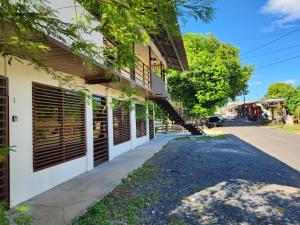 a house with shutters on the side of a street at Apartamentos La Primavera - Santiago Centro in Santiago