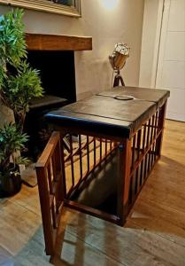 a small wooden table in a room with plants at Naughty Shades of Brighton in Brighton & Hove
