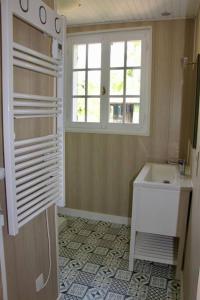 a bathroom with a sink and a window at Maison de Campagne in Chasnay