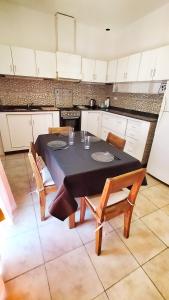 a kitchen with a table and chairs in a kitchen at Lavalle II in Venado Tuerto