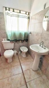 a bathroom with a toilet and a sink at Lavalle II in Venado Tuerto