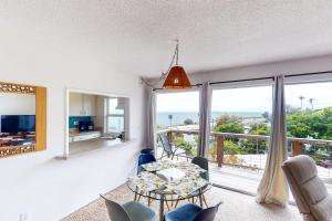 a dining room with a view of the ocean at Lillie Adventure in Summerland