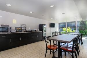 a kitchen and dining room with a table and chairs at The Beaucatcher, a Boutique Motel in Asheville