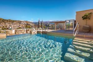 a swimming pool with a view of a city at Barceló Carmen Granada in Granada