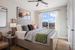 a bedroom with a large bed and a window at Rock Creek at Desert Color townhouse in St. George