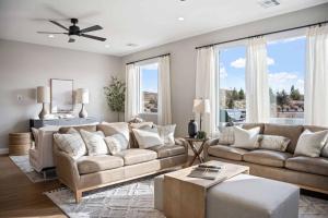a living room with a couch and a table at Rock Creek at Desert Color townhouse in St. George