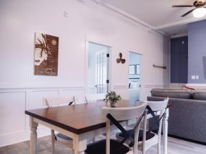 a dining room and living room with a table and chairs at Wild Horse Inn in Corolla