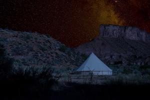 a pyramid tent in the desert at night at Gateway Glamping in Gateway