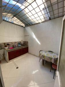a room with a table and a kitchen with a ceiling at Family house in the center of fez in Fez