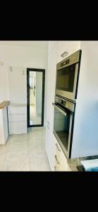 uma cozinha branca com um forno e um espelho em Apartment with swimming pool Lagotto em Trogir