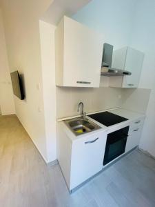 - une cuisine blanche avec évier et cuisinière dans l'établissement VIA ROMA, à Trapani