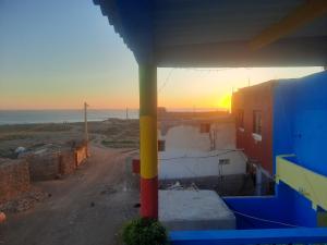 a view of the sunset from a building at Boilers Surf House in Tamri