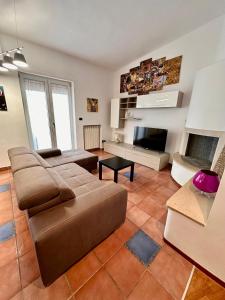 a living room with a couch and a fireplace at Brendon Suite in Brindisi