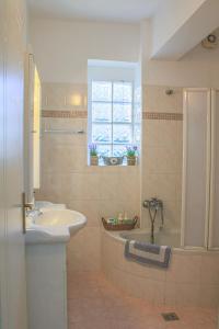 bagno con lavandino, vasca e lavandino di Διαμέρισμα στη χλόη Καστοριάς a Kastoria