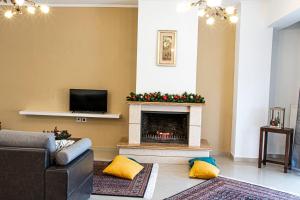 a living room with a fireplace with christmas decorations at Διαμέρισμα στη χλόη Καστοριάς in Kastoria