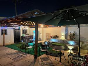 a patio with a table and chairs under an umbrella at Karjel Homes Apartments in Sunyani