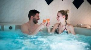 a man and woman in a bathtub drinking champagne at La Maison Patricia in Aramon +21 photos