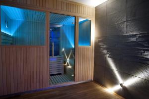 a room with a glass door and a window at Hôtel Le Grand Tétras in Font-Romeu