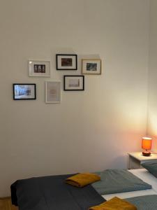 a bedroom with a bed and pictures on the wall at Maria Suite in Budapest