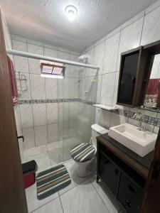 a bathroom with a shower and a toilet and a sink at Casa na Cachoeira Do Bom Jesus s in Florianópolis