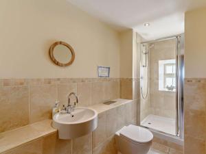 a bathroom with a sink and a toilet and a shower at 3 Bed in Nr Bamburgh CN069 in Kyloe +19 photos