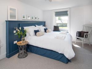a blue and white bedroom with a large bed at 4 Bed in Bamburgh CN089 in Bamburgh