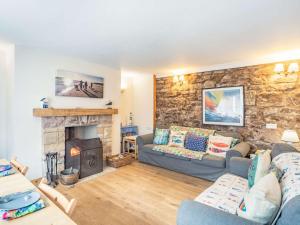 a living room with a couch and a fireplace at 2 Bed in Seahouses CN116 in Seahouses