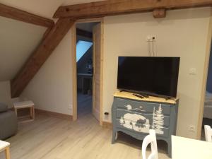 a living room with a flat screen tv on a dresser at la grande ourse in Planay