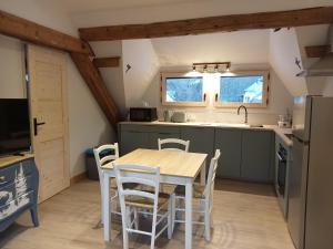 a kitchen with a table and chairs in a room at la grande ourse in Planay