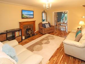 a living room with a couch and a fire place at 4 Bed in Druridge Bay CN102 in Hadston